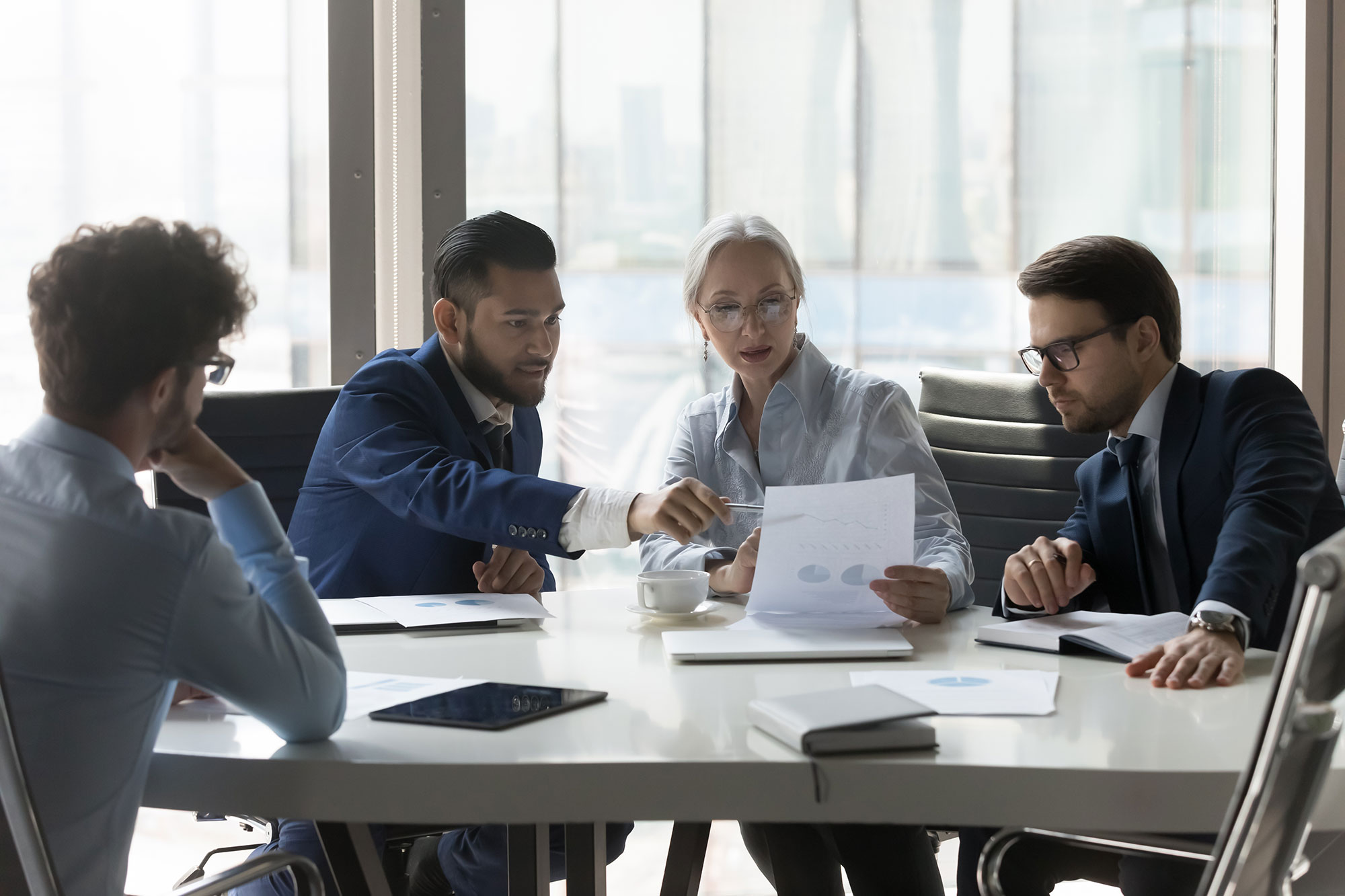 serious multiracial older young businesspeople gathered